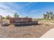 Stone-based sign features the community's name with a serene fountain and pond in the backdrop at 24670 N 171St Ln, Surprise, AZ 85387