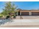 Charming single-story home featuring a tile roof, desert landscaping, and a two-car garage at 24670 N 171St Ln, Surprise, AZ 85387