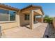 Covered patio with brick pavers, complementing the home's architecture and providing a cozy outdoor retreat at 24670 N 171St Ln, Surprise, AZ 85387