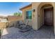 Inviting front porch with two chairs and a stone tile floor; charming curb appeal at 24670 N 171St Ln, Surprise, AZ 85387