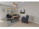 Bright living room featuring modern furniture, tile floors, and a ceiling fan at 24670 N 171St Ln, Surprise, AZ 85387