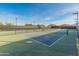 Close up of a fenced community pickleball court with a blue and green surface under a clear blue sky at 24670 N 171St Ln, Surprise, AZ 85387