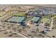 Aerial of multiple tennis courts, bocce ball and pickleball courts with a clubhouse and parking at 24670 N 171St Ln, Surprise, AZ 85387