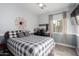 Cozy bedroom showcasing a patterned quilt, modern wall decor, and bright natural light at 2528 E La Costa Dr, Chandler, AZ 85249