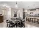 Inviting dining area with a round table, modern lighting, and convenient access to the kitchen, creating a welcoming atmosphere at 2528 E La Costa Dr, Chandler, AZ 85249