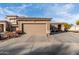 Charming home showcasing a large front entry garage and well maintained landscaping with a seating area at 2528 E La Costa Dr, Chandler, AZ 85249