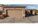 Large tan garage door with well maintained landscaping and a seating area at 2528 E La Costa Dr, Chandler, AZ 85249