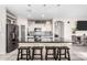 Stylish kitchen boasting a large island with seating, sleek countertops, and modern cabinetry, perfect for culinary enthusiasts at 2528 E La Costa Dr, Chandler, AZ 85249