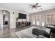 Spacious living room with grey flooring, ceiling fan, and a large tv on the wall at 2528 E La Costa Dr, Chandler, AZ 85249