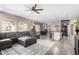 An open concept living room with a large grey couch, kitchen island, and dining room at 2528 E La Costa Dr, Chandler, AZ 85249