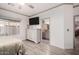 Bright main bedroom featuring wood-look floors, stylish dresser, and ensuite bathroom at 2528 E La Costa Dr, Chandler, AZ 85249