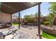 Cozy back patio featuring a pergola, brick flooring, and a seating area perfect for outdoor relaxation at 2645 W Florentine Rd, Phoenix, AZ 85086