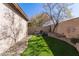 Serene backyard with artificial grass, stone landscaping, a charming bench and natural beauty creating a private retreat at 2645 W Florentine Rd, Phoenix, AZ 85086