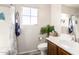 Clean bathroom featuring a white sink, wooden cabinets, toilet, bathtub/shower with white and blue finishes at 2645 W Florentine Rd, Phoenix, AZ 85086