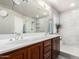 Elegant bathroom featuring a double sink vanity, a glass-enclosed shower with tile walls and a white countertop at 2645 W Florentine Rd, Phoenix, AZ 85086