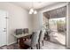 Dining room with glass-top table, upholstered chairs, and sliding glass doors to the patio at 2645 W Florentine Rd, Phoenix, AZ 85086