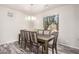 Elegant dining room featuring a wooden table with seating for eight and a large window at 2645 W Florentine Rd, Phoenix, AZ 85086