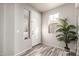 Bright entryway with wood-look tile flooring and ample natural light, showcasing a modern design at 2645 W Florentine Rd, Phoenix, AZ 85086