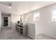 Bright hallway featuring neutral-colored walls, carpet flooring, and a cabinet with glass doors at 2645 W Florentine Rd, Phoenix, AZ 85086