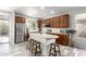 Bright kitchen with stainless steel appliances, central island with counter seating, and wood-finish cabinetry at 2645 W Florentine Rd, Phoenix, AZ 85086