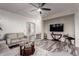 Comfortable living room with plush seating, modern ceiling fan, and entertainment area at 2645 W Florentine Rd, Phoenix, AZ 85086