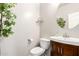 Charming powder room featuring a vanity with a round mirror and decorative accents at 2645 W Florentine Rd, Phoenix, AZ 85086