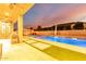 Backyard Oasis: Pool with waterfall feature, outdoor kitchen, and grassy pavers at 2799 E Waterman St, Gilbert, AZ 85297