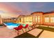 Beautiful backyard pool with lounge chairs, grassy pavers, and sunset views at 2799 E Waterman St, Gilbert, AZ 85297