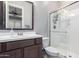 Bathroom featuring dark cabinets, vanity, large mirror, toilet, and glass enclosed shower at 2799 E Waterman St, Gilbert, AZ 85297