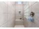 A tiled shower features a small bench, glass block window, and a built-in niche for toiletries at 2799 E Waterman St, Gilbert, AZ 85297