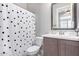 Cozy bathroom features a polka-dotted curtain, a modern vanity, and a framed mirror at 2799 E Waterman St, Gilbert, AZ 85297