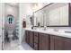 Bright bathroom featuring double vanity, framed mirror, and arched window in the shower area at 2799 E Waterman St, Gilbert, AZ 85297