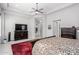 Spacious bedroom featuring tile floors, a ceiling fan, a patterned rug and a decorative dresser at 2799 E Waterman St, Gilbert, AZ 85297