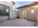 Private courtyard with beautiful stone walls, wrought iron gate, and manicured plants at 2799 E Waterman St, Gilbert, AZ 85297