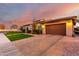 Attractive single-story home with a stone facade, paved driveway, two car garage and manicured lawn at 2799 E Waterman St, Gilbert, AZ 85297