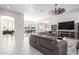 Open concept living room featuring tile floors, modern furnishings, and multiple windows at 2799 E Waterman St, Gilbert, AZ 85297