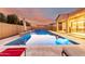 Gorgeous rectangular pool at dusk, enhanced with a baja step and water feature at 2799 E Waterman St, Gilbert, AZ 85297