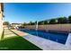 Beautiful blue swimming pool featuring a waterfall and lounge area in a private backyard oasis at 2799 E Waterman St, Gilbert, AZ 85297