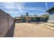 Large gravel backyard offering various outdoor living possibilities with shaded structures and privacy fencing at 2902 E Escondido Ave, Mesa, AZ 85204