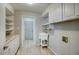 Well-organized laundry room with white cabinetry, granite counters, utility sink, and ample storage at 2902 E Escondido Ave, Mesa, AZ 85204