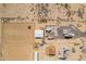 Overhead view of expansive horse property featuring a well-equipped arena, shelters, and adjacent residential buildings at 29409 N 220Th Ave, Wittmann, AZ 85361