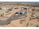 Aerial view of a single-Gathering home surrounded by equestrian facilities, with horse shelters and open space at 29409 N 220Th Ave, Wittmann, AZ 85361