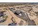 An aerial view of a single-Gathering home with large property, horse facilities, and desert landscaping at 29409 N 220Th Ave, Wittmann, AZ 85361