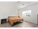 Bright bedroom with wood-look floors, a simple frame bed and plenty of light at 29409 N 220Th Ave, Wittmann, AZ 85361