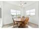 Bright dining room with a wood table, four chairs, wood-look floors and bright natural light at 29409 N 220Th Ave, Wittmann, AZ 85361