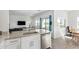 View of the kitchen island with a sink and a dishwasher, and the living room with access to the outside at 29409 N 220Th Ave, Wittmann, AZ 85361