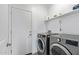 Functional laundry room with modern washer and dryer units at 29409 N 220Th Ave, Wittmann, AZ 85361