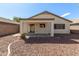 View of the backyard, featuring desert landscaping and covered patio at 30169 N Sunray Dr, San Tan Valley, AZ 85143