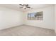 Bright bedroom with neutral carpeting, a ceiling fan, and a window overlooking the backyard at 30169 N Sunray Dr, San Tan Valley, AZ 85143