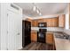 Well-lit kitchen with stainless steel appliances and wooden cabinets at 30169 N Sunray Dr, San Tan Valley, AZ 85143